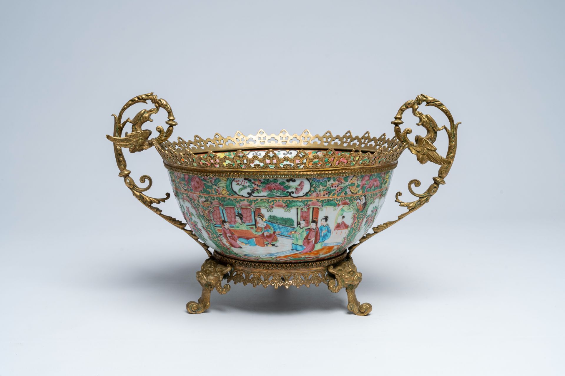 A Chinese Canton famille rose brass mounted bowl with palace scenes and floral design, 19th C.