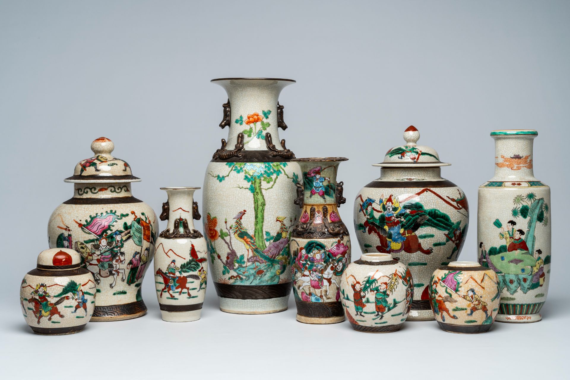 A varied collection of Chinese Nanking crackle glazed famille rose and verte vases and jars with war