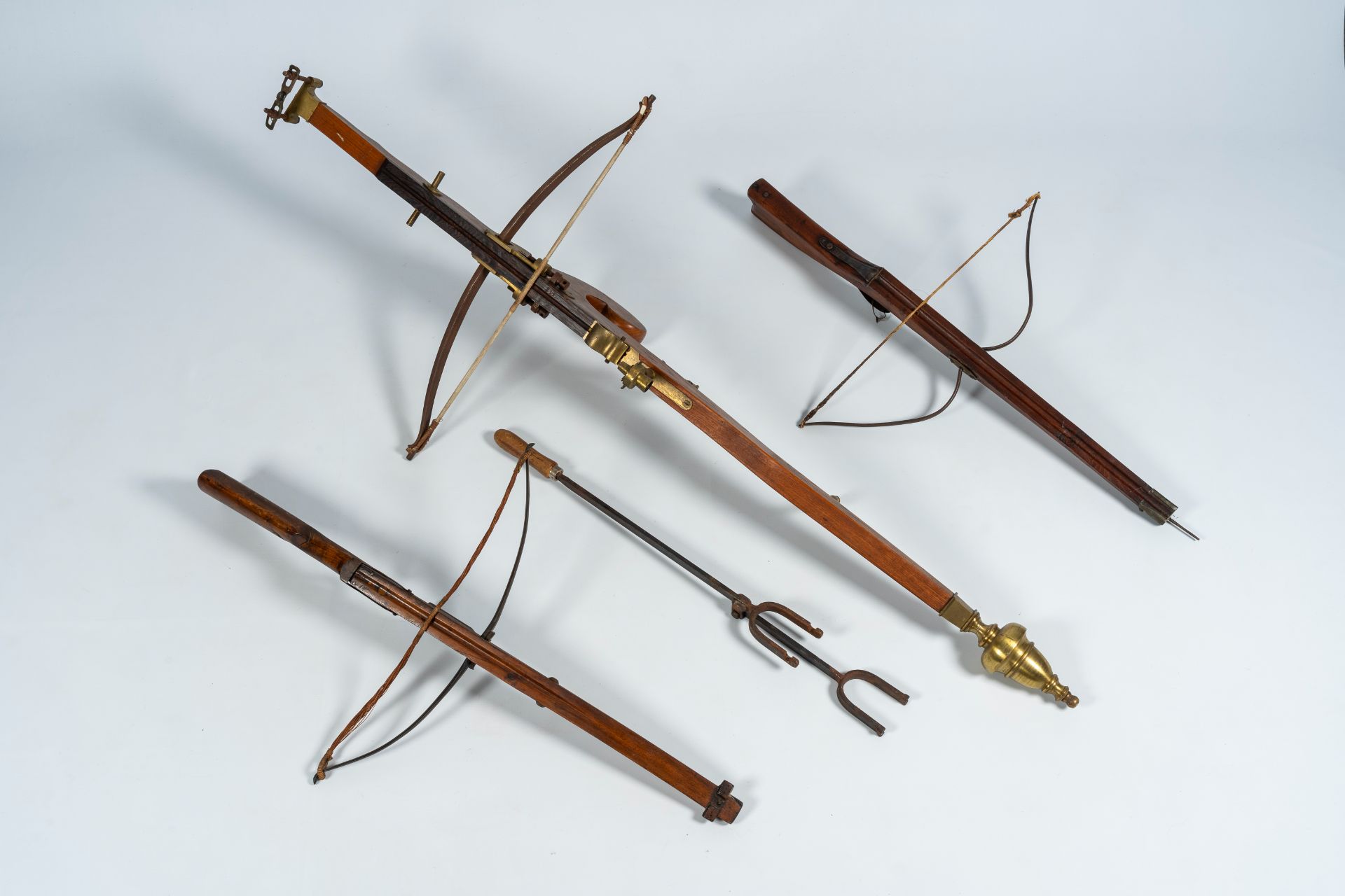 Three crossbows in the medieval manner and a bow tensioner, 19th/20th C.