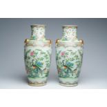 A pair of Chinese Canton famille rose vases with birds among blossoming branches, 19th C.