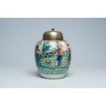 A Chinese famille verte jar with an animated palace scene and a silver-plated cover, 19th C.