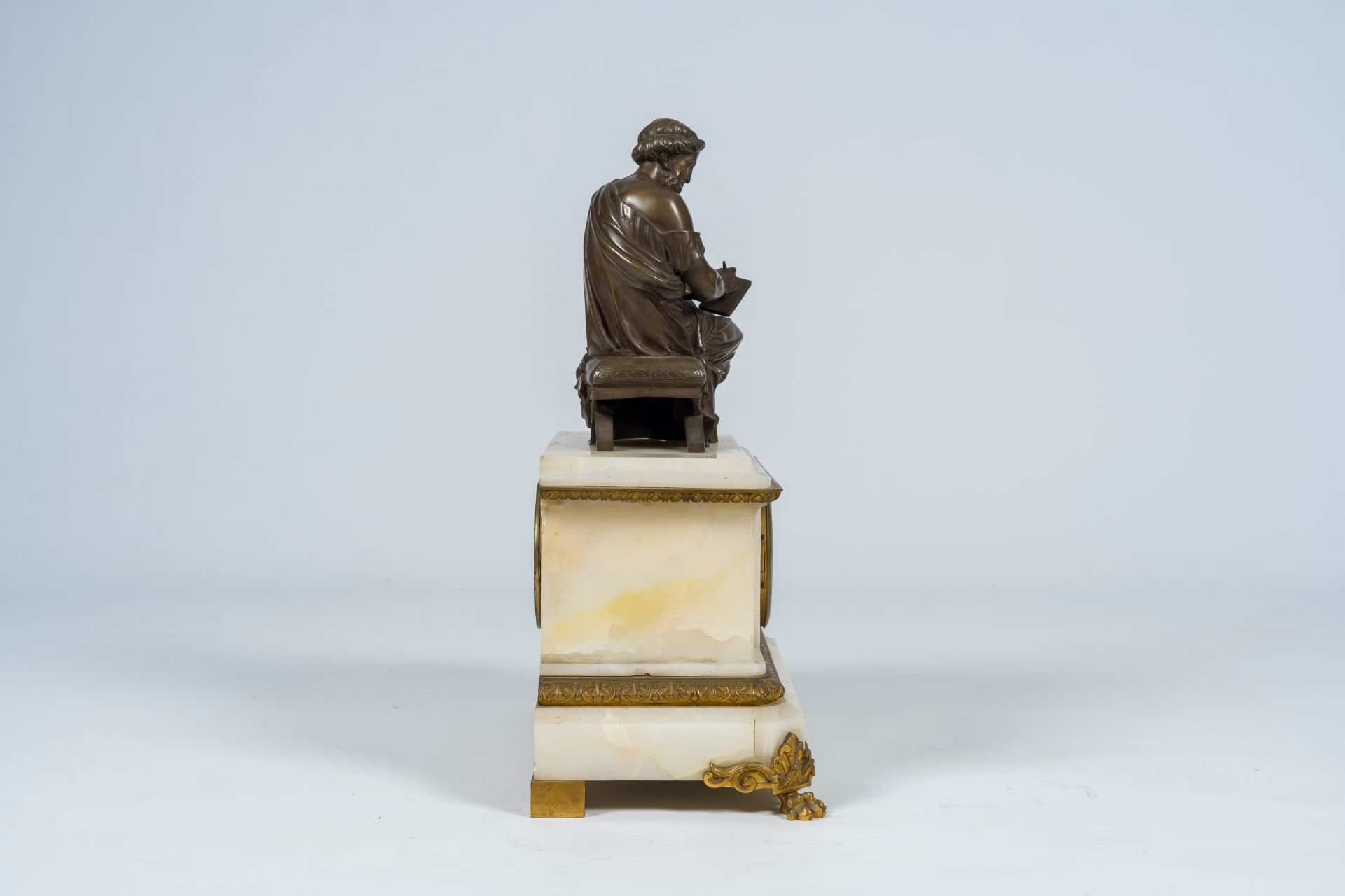 A French gilt and patinated bronze mounted white onyx mantel clock with a legist, 19th C. - Image 5 of 10