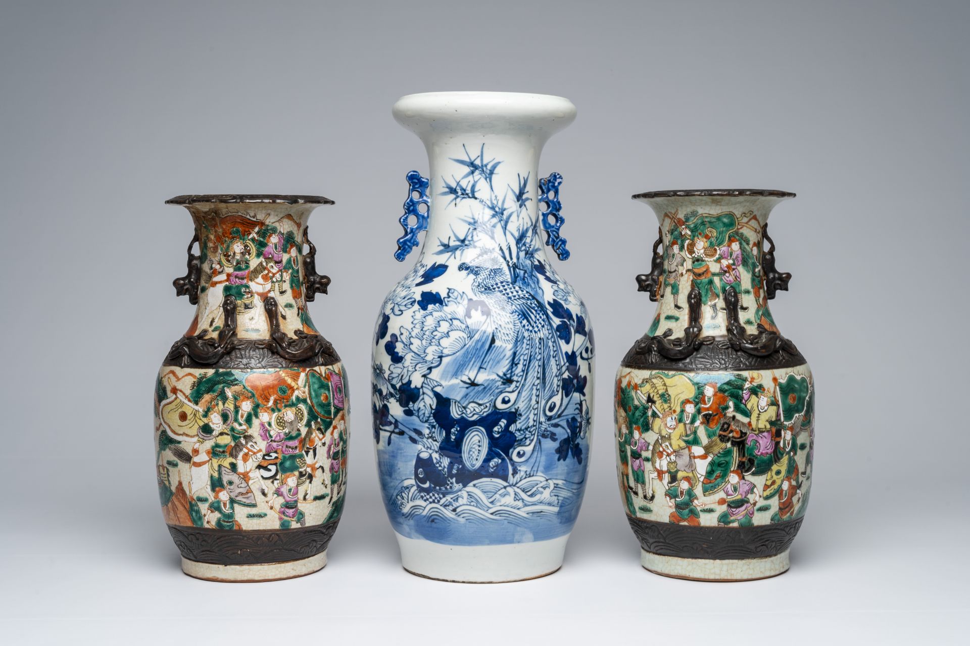 A pair of Chinese Nanking crackle glazed famille rose 'warrior' vases and a blue and white 'phoenix'