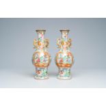 A pair of Chinese Canton famille rose vases and with palace scenes and floral design, 19th C.