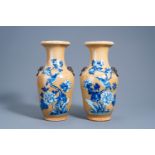 A pair of Chinese Nanking crackle glazed blue and white 'cafÃ© au lait' ground vases with a bird on