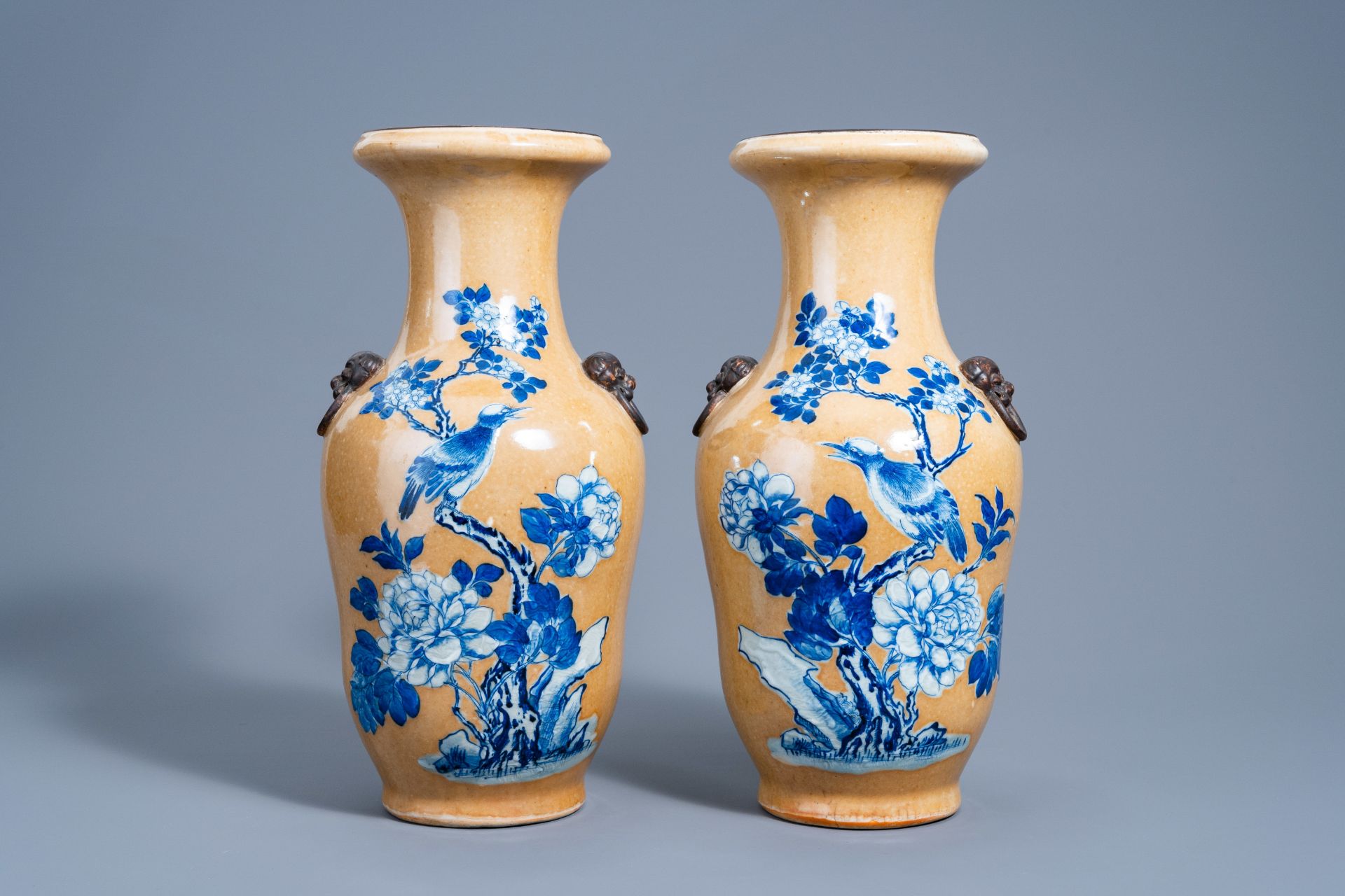 A pair of Chinese Nanking crackle glazed blue and white 'cafÃ© au lait' ground vases with a bird on