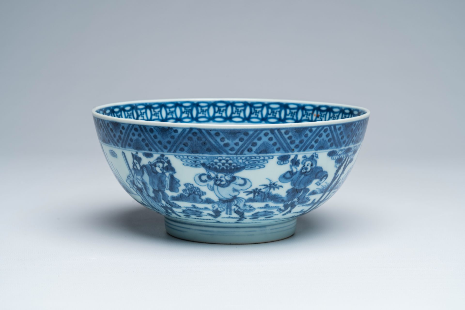 A Chinese blue and white bowl with a dromedary and warriors in a landscape and a medallion with a dr