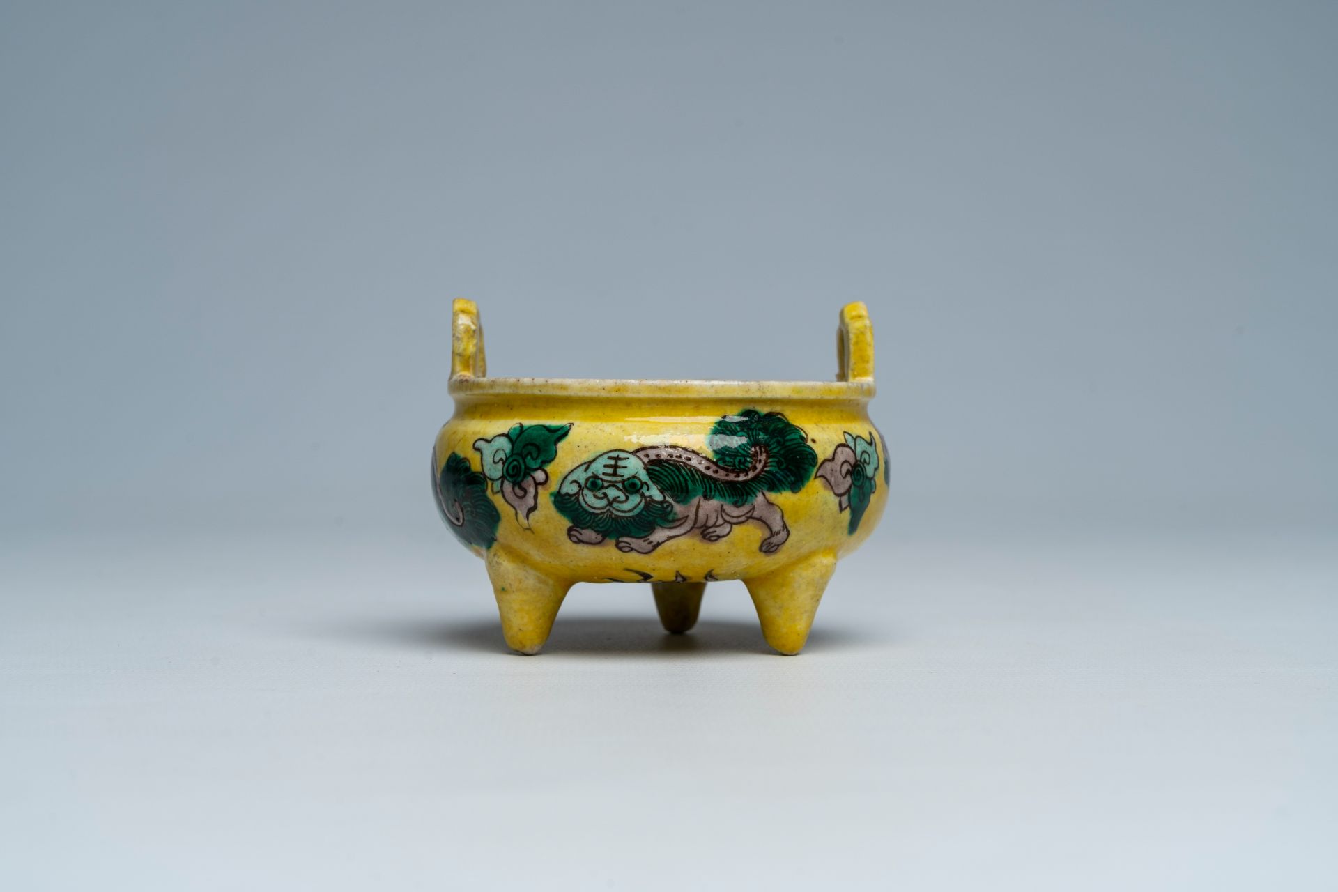 A Chinese verte biscuit yellow-ground 'Buddhist lions' tripod censer, 19th C. - Image 5 of 8