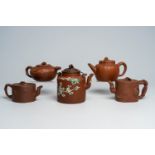 Five Chinese Yixing stoneware teapots and covers with floral and relief design, 19th/20th C.