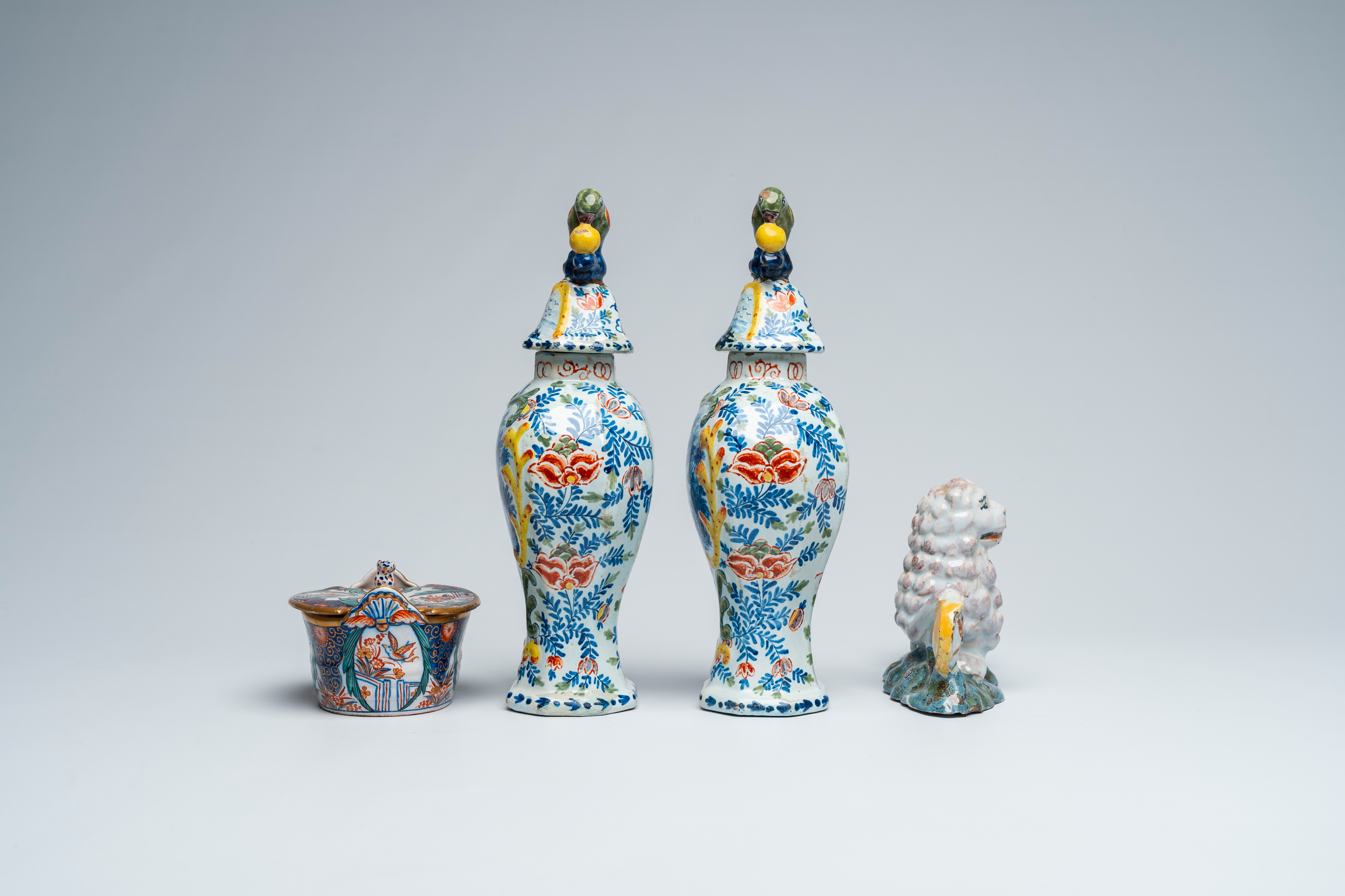 A pair of polychrome Delft vases and covers, a butter tub and a reclining lion, 18th and 19th C. - Image 4 of 7