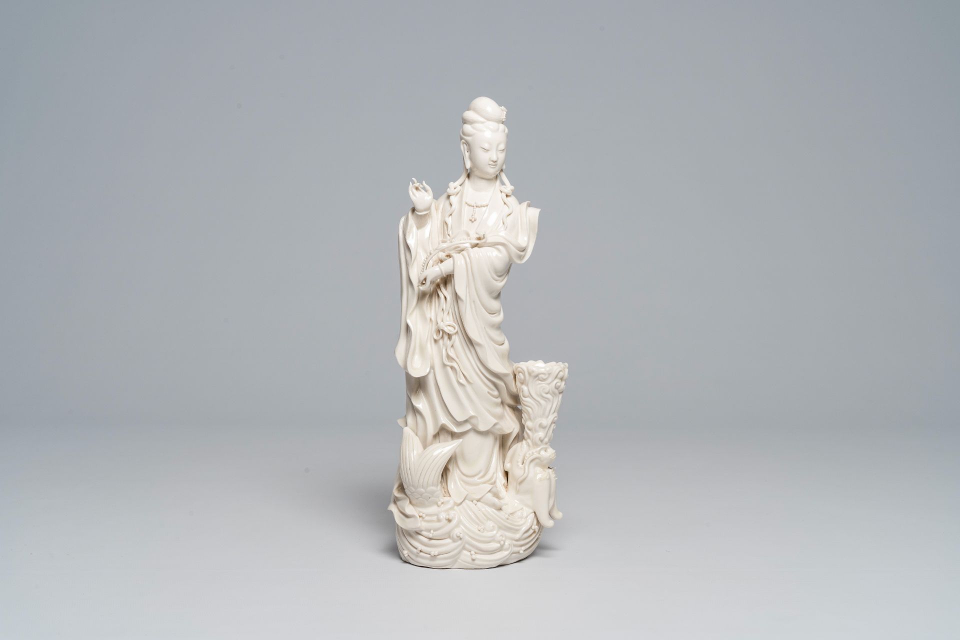 A Chinese Dehua blanc de Chine figure of Guanyin standing on a sea dragon, 20th C.