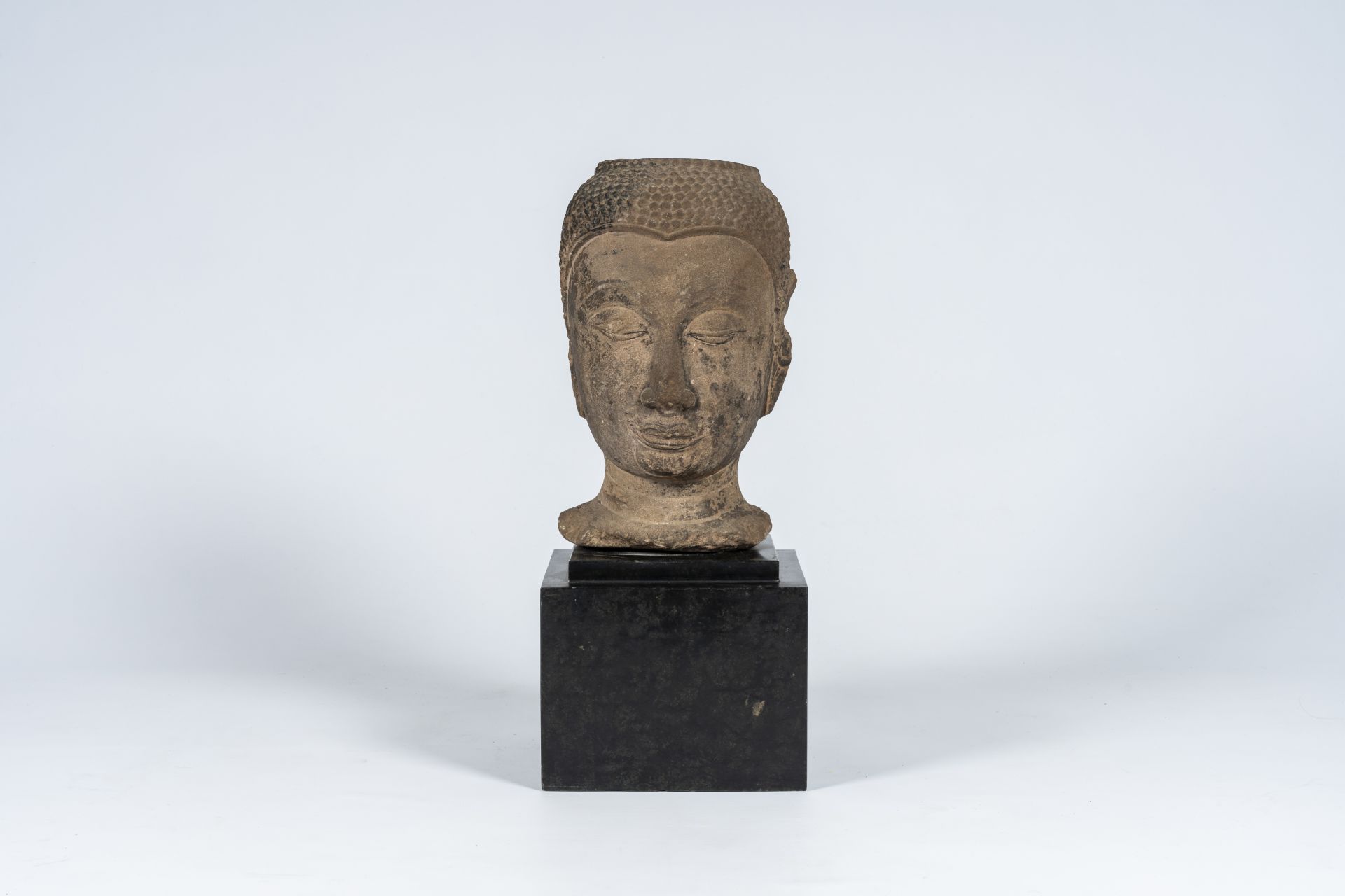 A Thai stone Buddha head, Ayutthaya period, 16th/17th C.