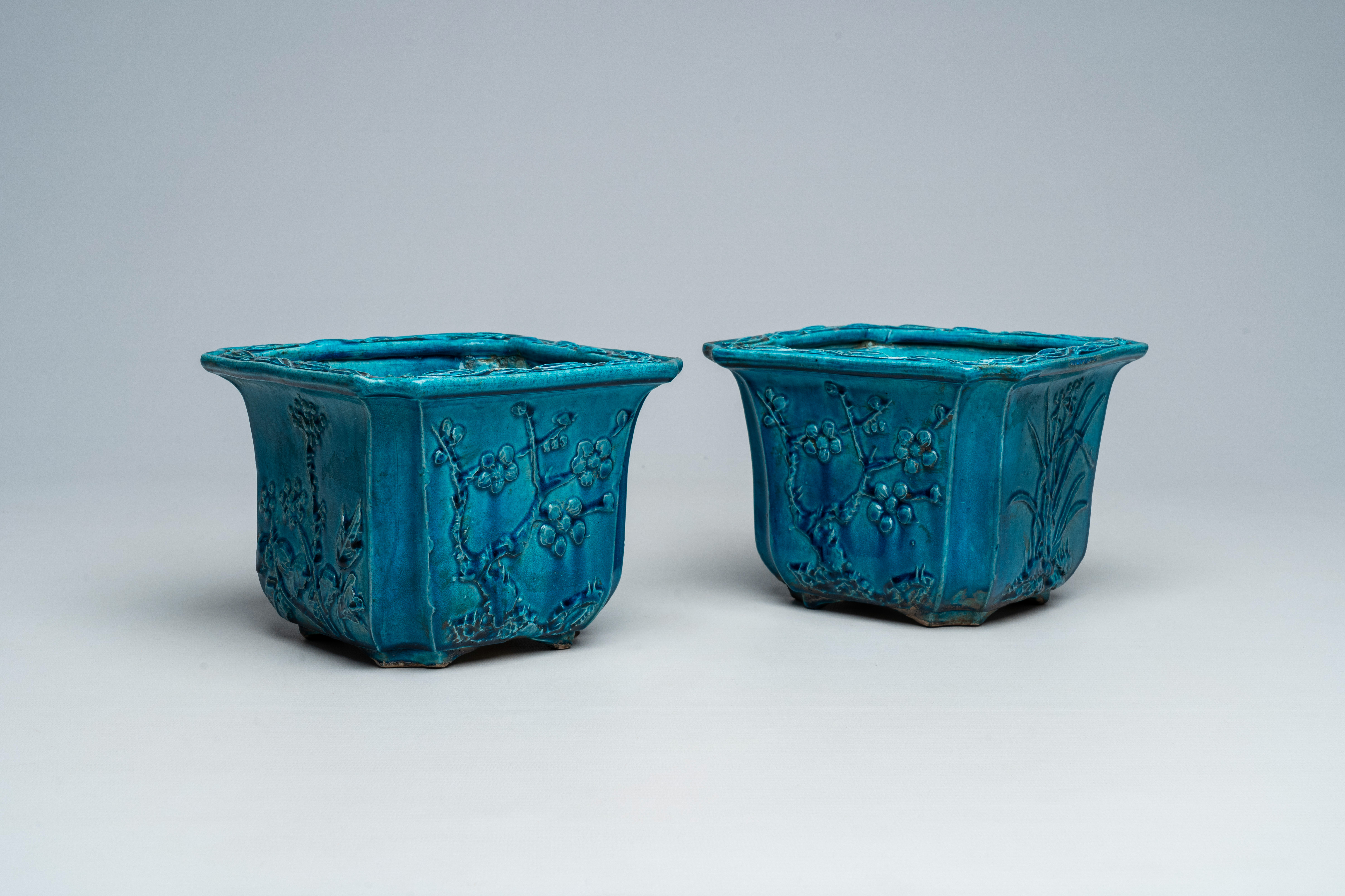 A pair of Chinese monochrome turquoise jardiniÃ¨res with floral relief design, 19th C.