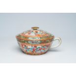 A Chinese Canton famille rose chamber pot with palace scenes and floral design, 19th C.