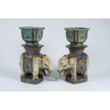 A pair of Chinese or Vietnamese polychrome pottery elephant-shaped pedestals and a pair of jardiniÃ¨