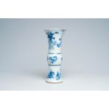 A Chinese blue and white Kangxi style 'gu' vase with figures in a landscape and floral design, 20th