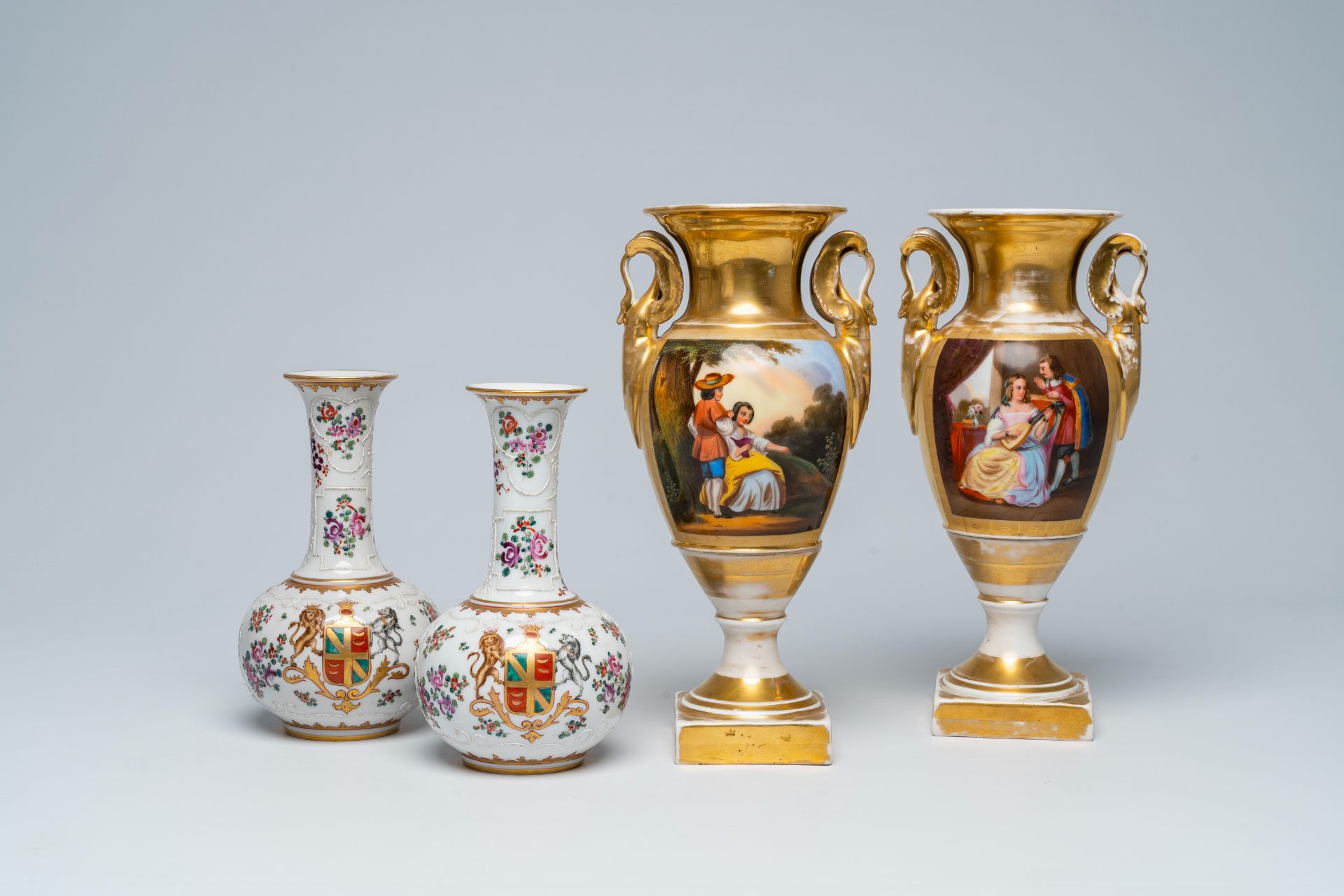 A pair of French gilt and polychrome vases and a pair of famille rose style vases with a coat of arm