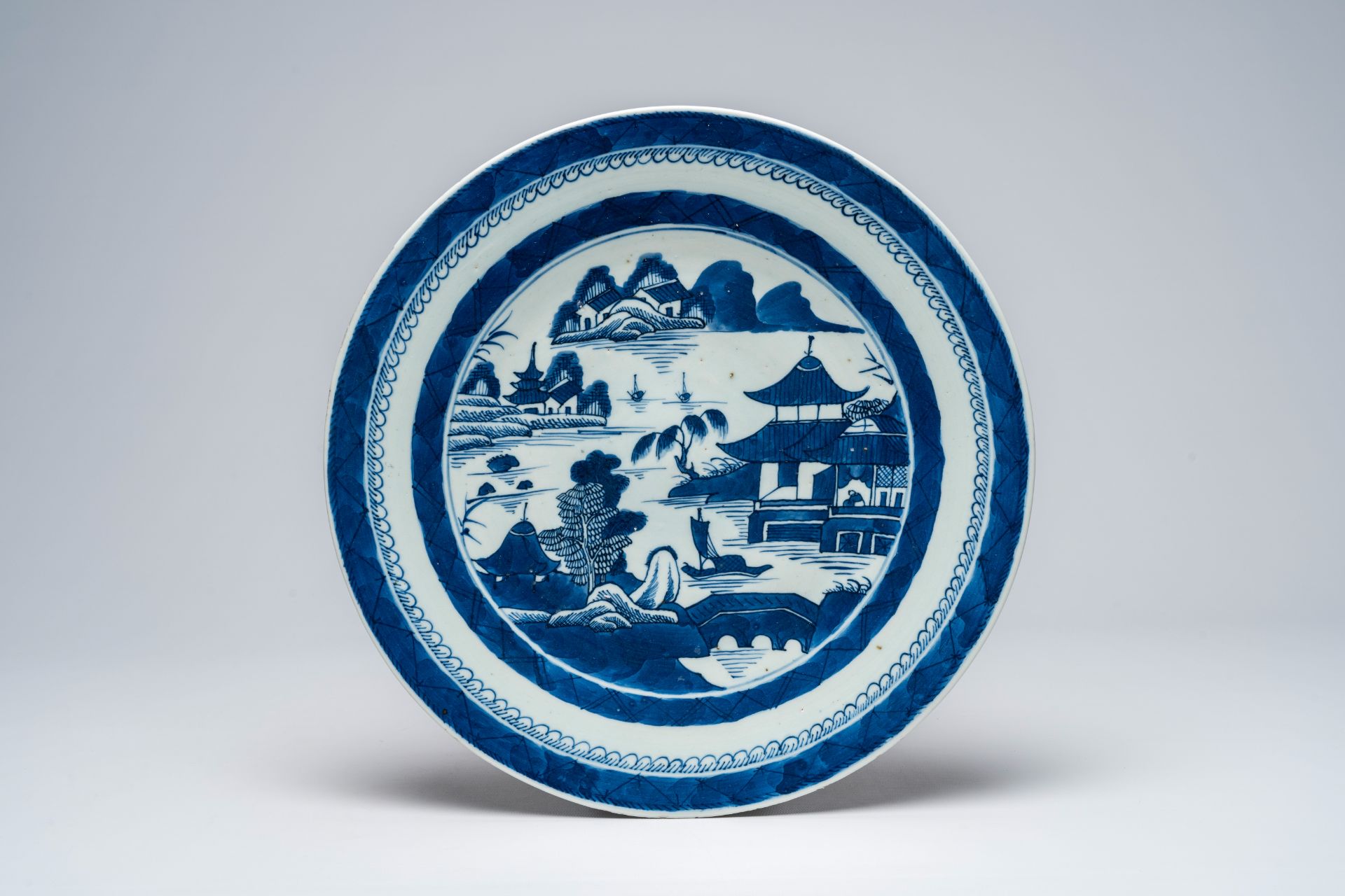 Two Chinese blue and white chargers with a landscape and antiquities, 19th C. - Image 2 of 5
