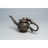 A Chinese silver teapot and cover with a dragon-shaped handle and a makara-shaped spout, 19th C.