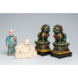 A Chinese blanc de Chine figure of Buddha, a pair of sancai glazed Buddhist lions and a famille rose