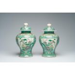 A pair of Chinese verte biscuit vases and covers with landscapes and floral design, 19th C.