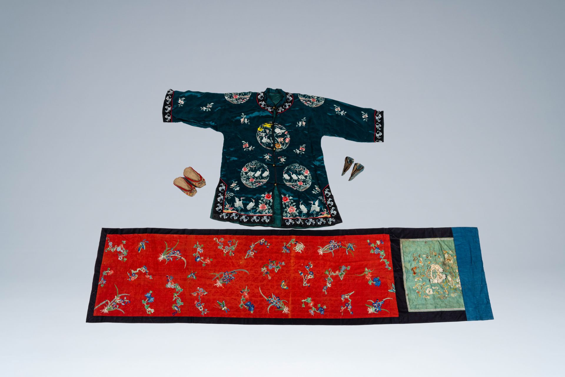 A Chinese embroidered silk altar cloth, a jacket with cranes and two pairs of shoes, 19th C.