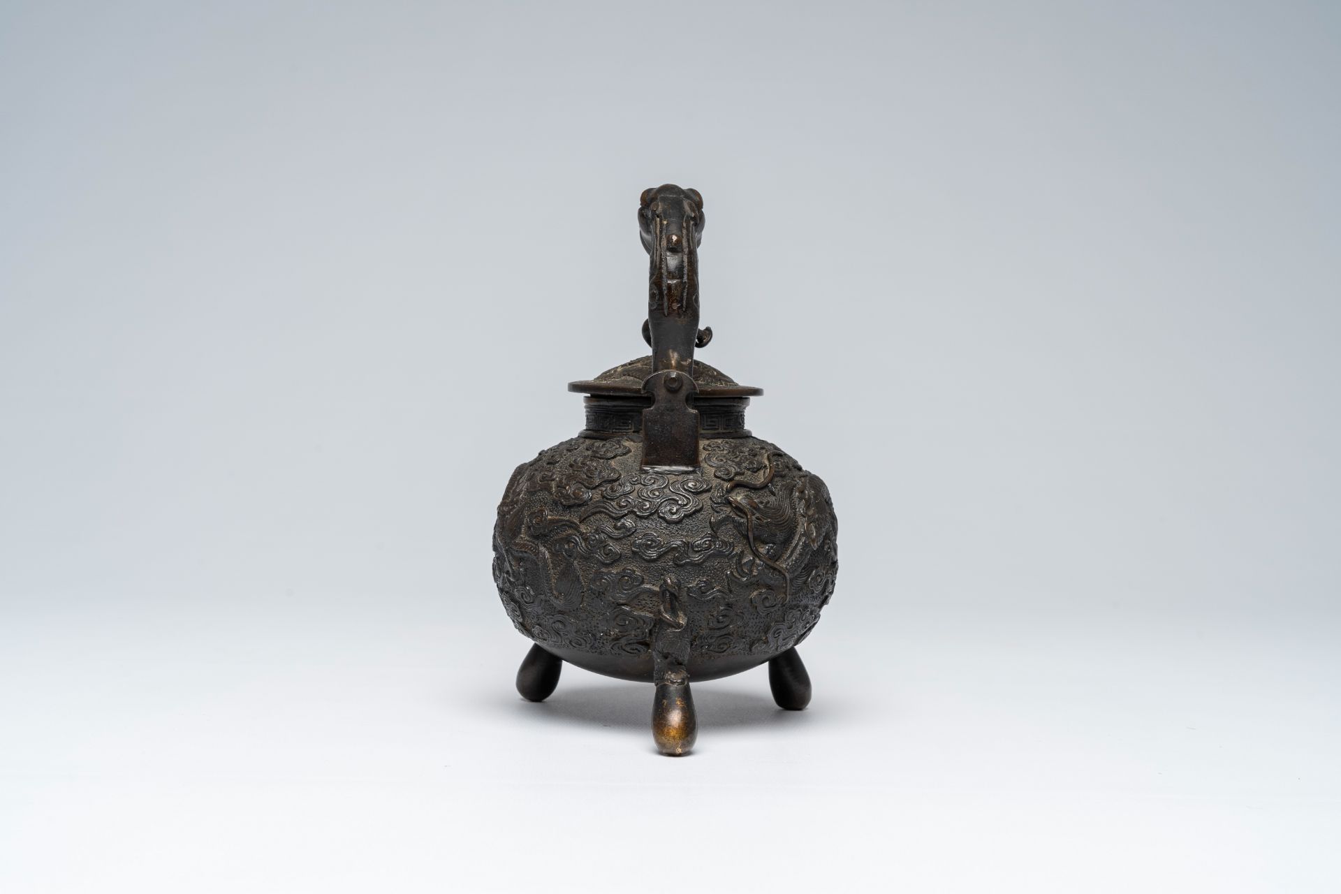 A Chinese tripod bronze teapot and cover with dragon relief design and double gourds, ca. 1900 - Image 6 of 8