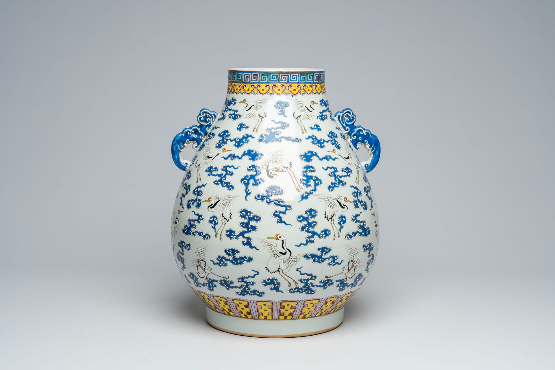 A Chinese famille rose 'hu' vase with cranes between clouds, Qianlong mark, 20th C.