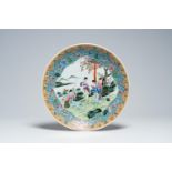 A Chinese famille rose charger with ladies relaxing in a garden by a river, Qianlong mark, Republic,