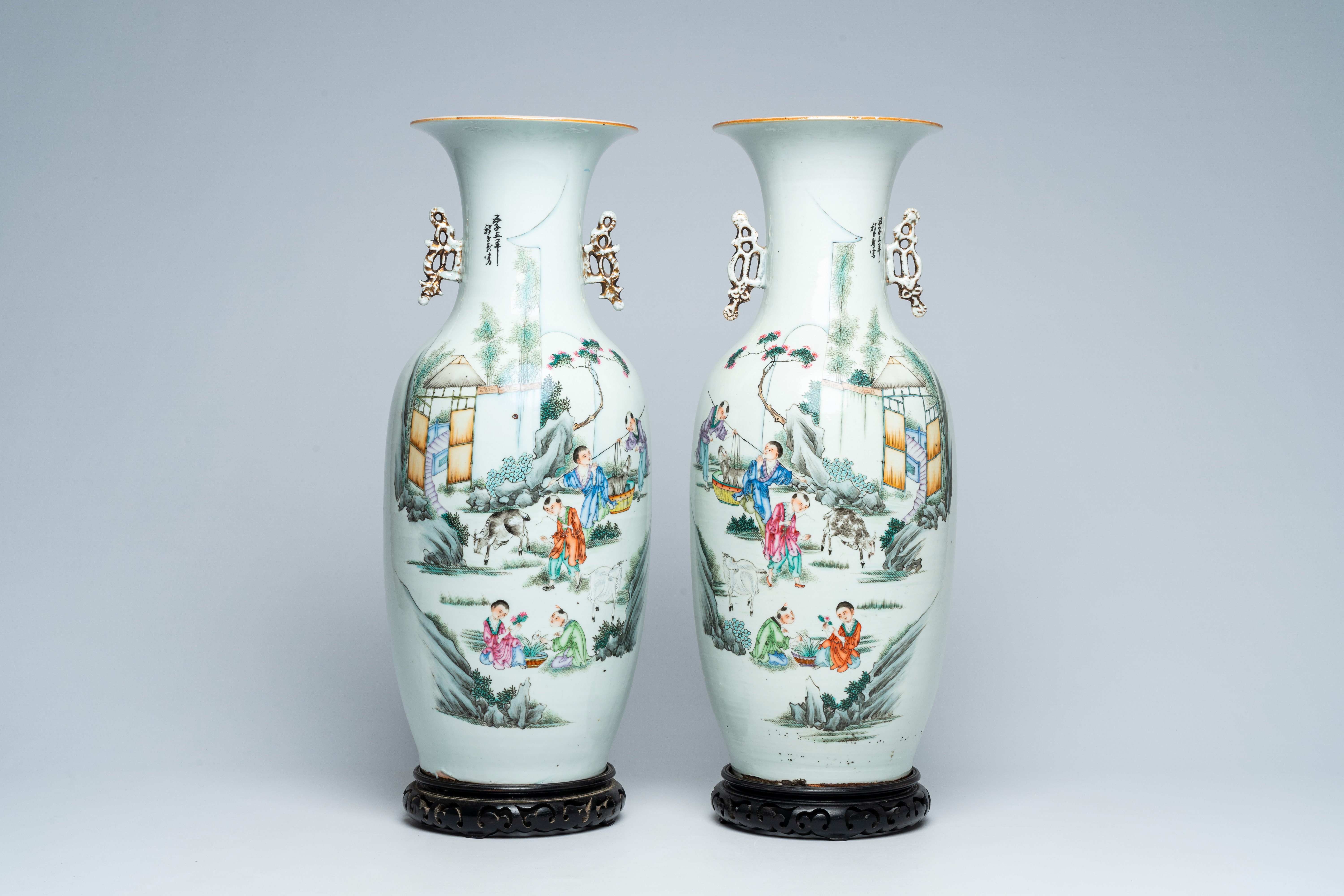 A pair of Chinese famille rose vases with playing children and goats in a landscape, 19th/20th C.