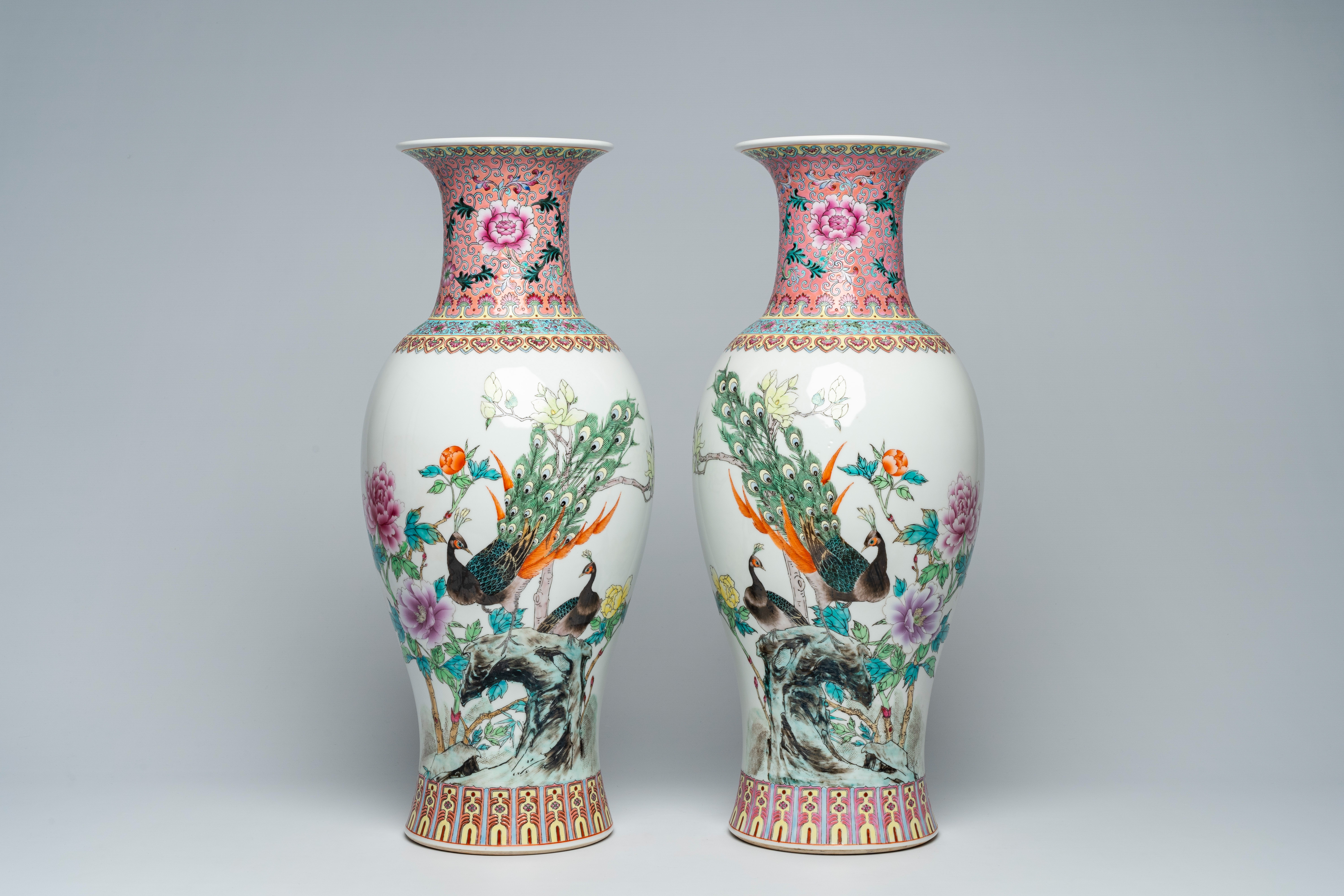 A pair of Chinese famille rose baluster vases with peacocks among blossoming branches, Jingdezhen ma