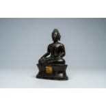 A Thai patinated bronze figure of a seated Buddha, possibly 16th C.