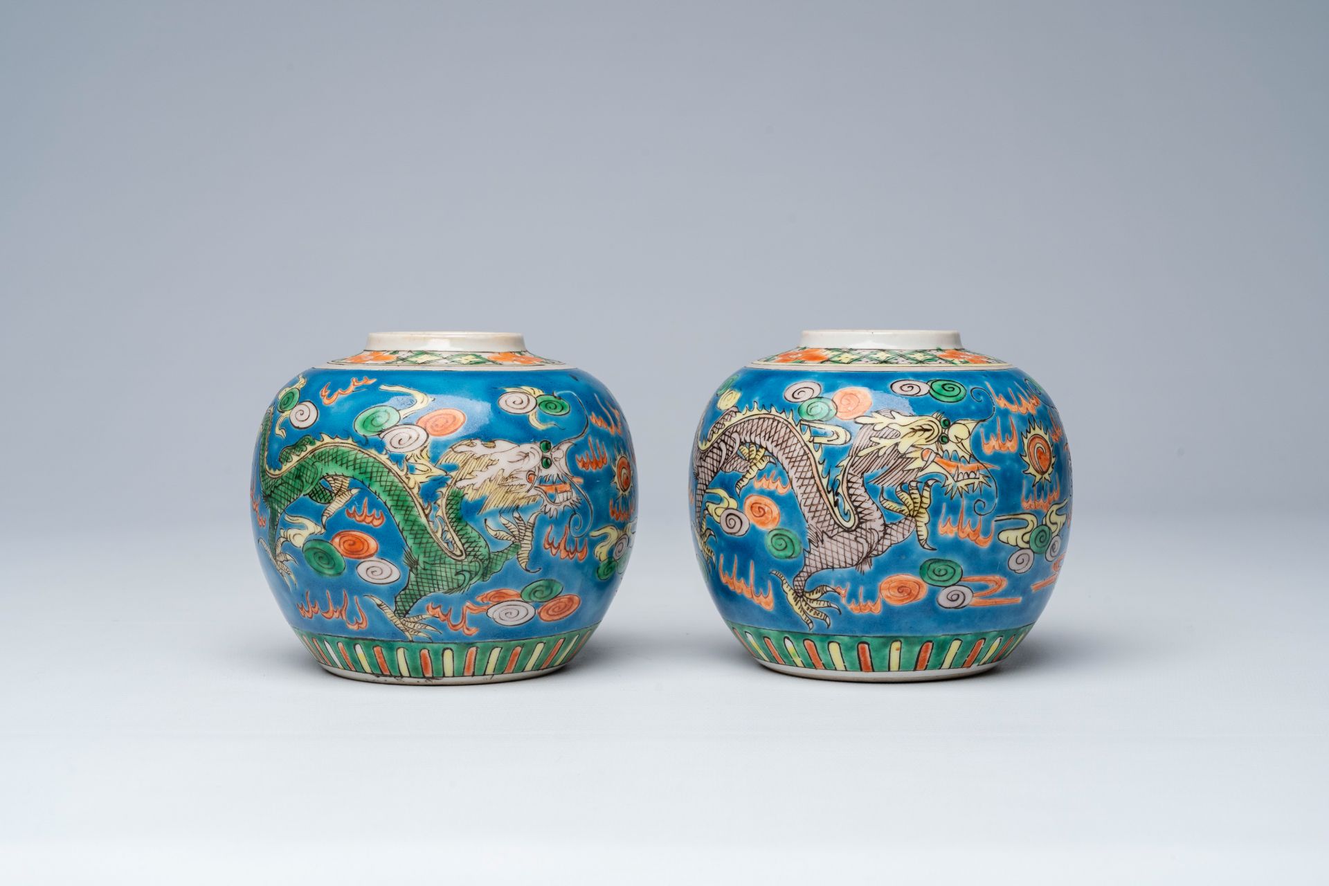 A pair of Chinese blue ground famille verte 'dragons chasing the pearl' ginger jars, 19th C. - Image 5 of 7