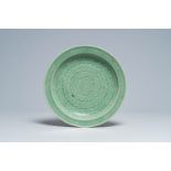 A Chinese celadon dish with incised lotus design, 19th C.