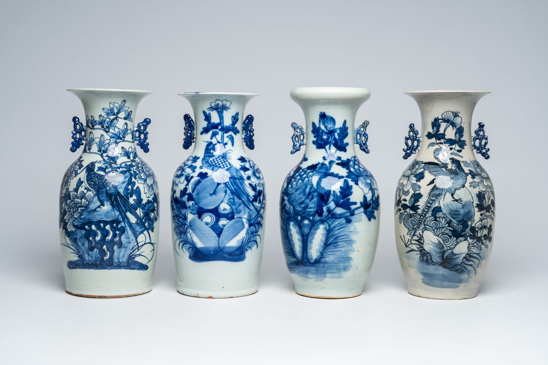 Four Chinese blue and white vases with birds among blossoming branches, 19th C.