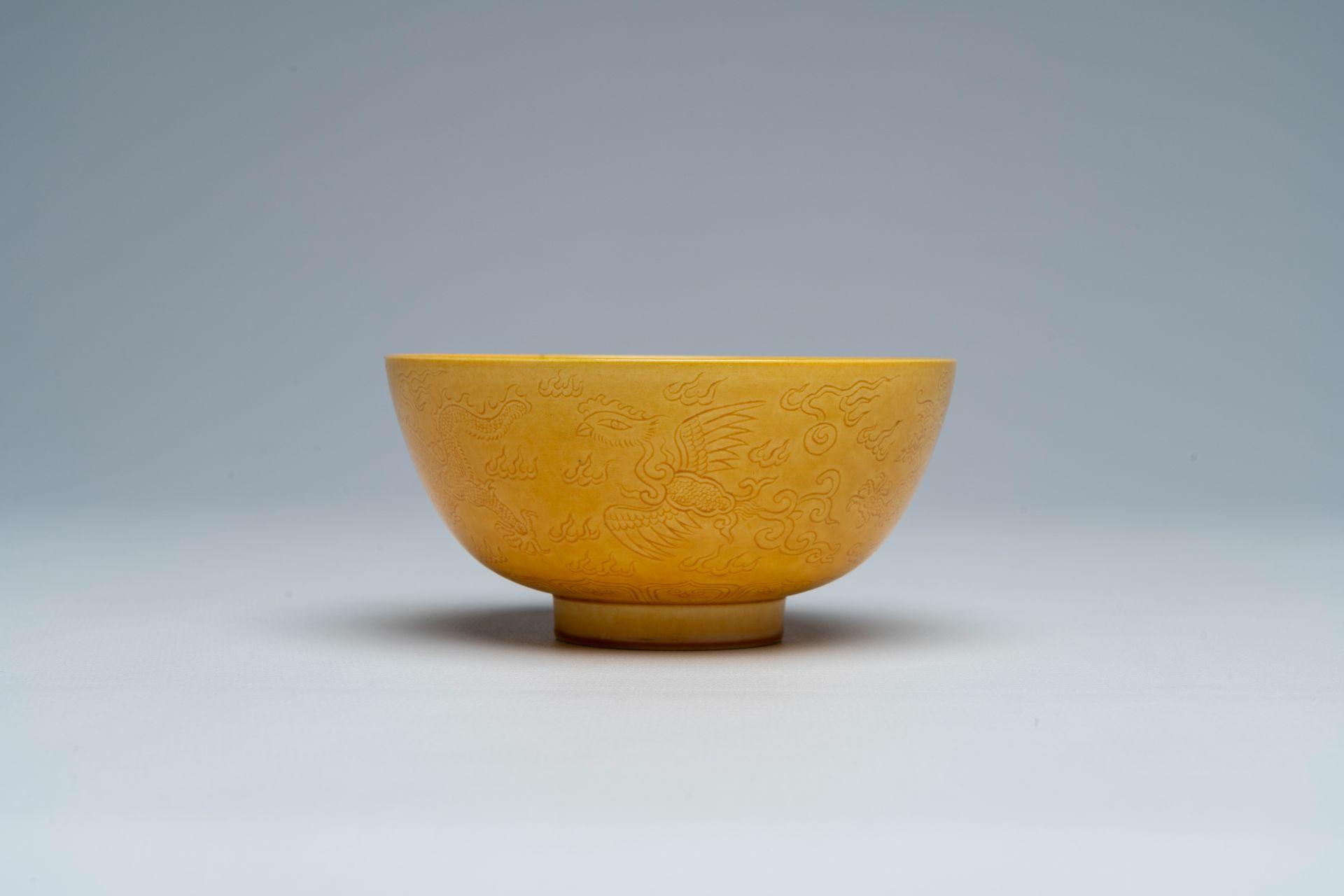 A Chinese monochrome yellow bowl with incised design of dragons and phoenixes, Jiaqing mark, 19th/20 - Image 3 of 7