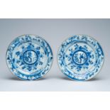 A pair of Chinese blue and white plates with raised central medallions, Yongzheng