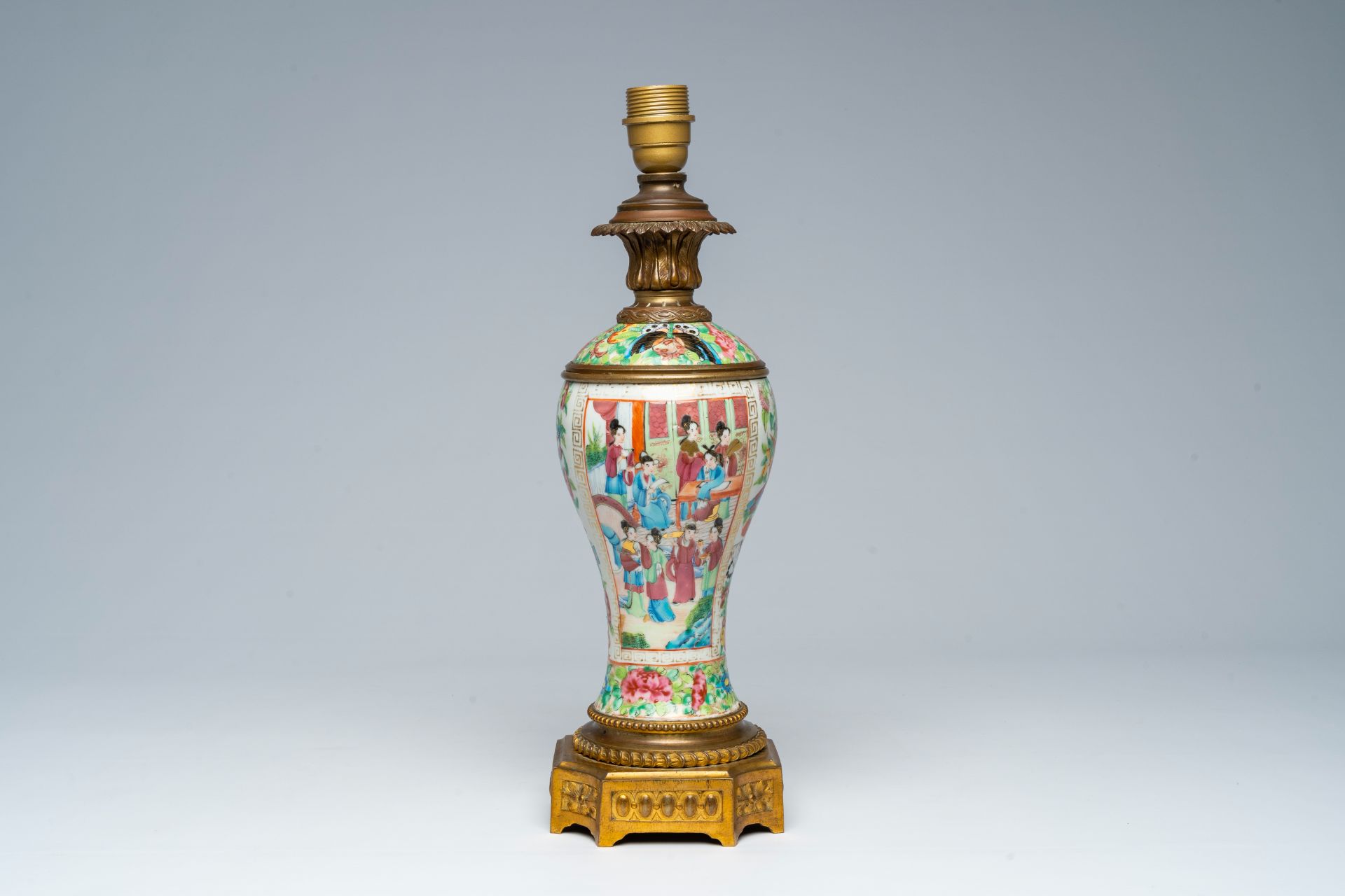 A Chinese Canton famille rose vase with palace scenes and floral design mounted as a lamp, 19th C.