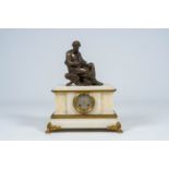 A French gilt and patinated bronze mounted white onyx mantel clock with a legist, 19th C.