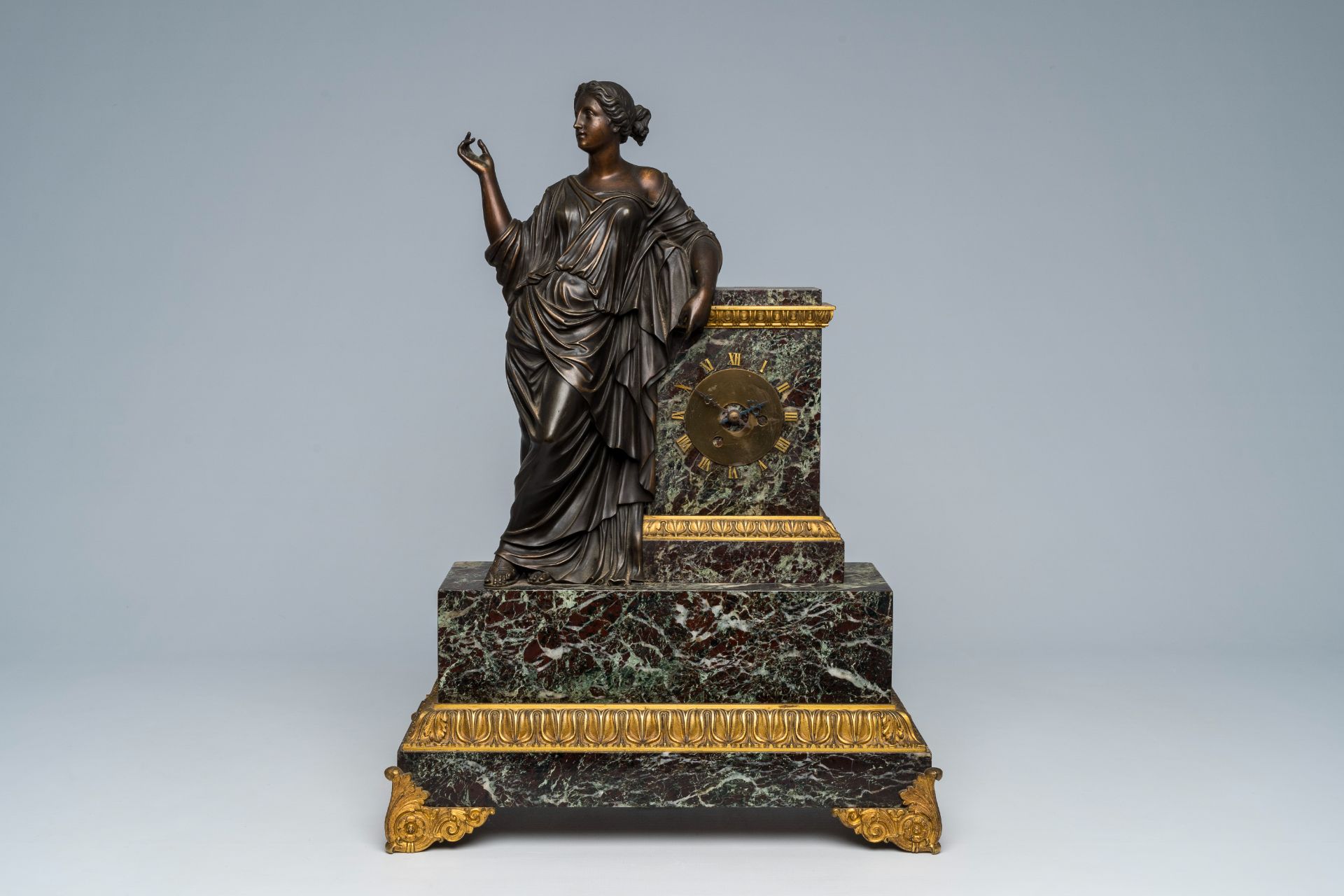 A French gilt and patinated bronze mounted marble mantel clock with an elegant lady, 19th C.