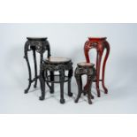 Four Chinese open worked carved wood stands with marble top, 19th/20th C.