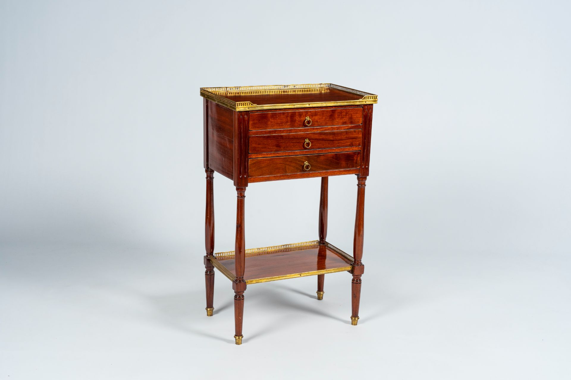A French mahogany gilt brass mounted side table with three drawers, late 19th C. - Image 2 of 8