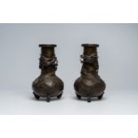 A pair of Japanese bronze relief decorated 'dragon' vases, Meiji, ca. 1900