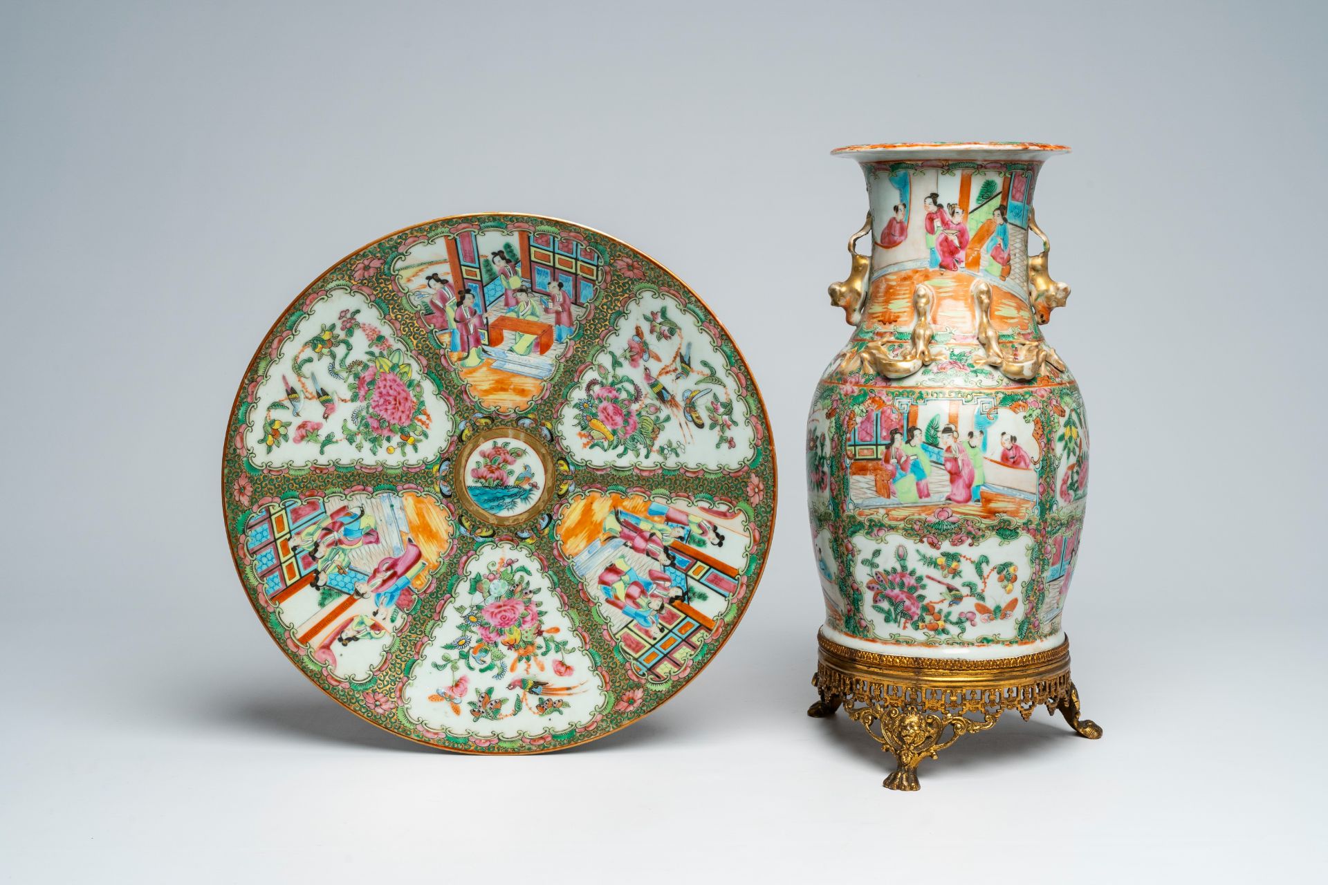 A Chinese Canton famille rose gilt brass mounted vase and a charger with palace scenes and floral de