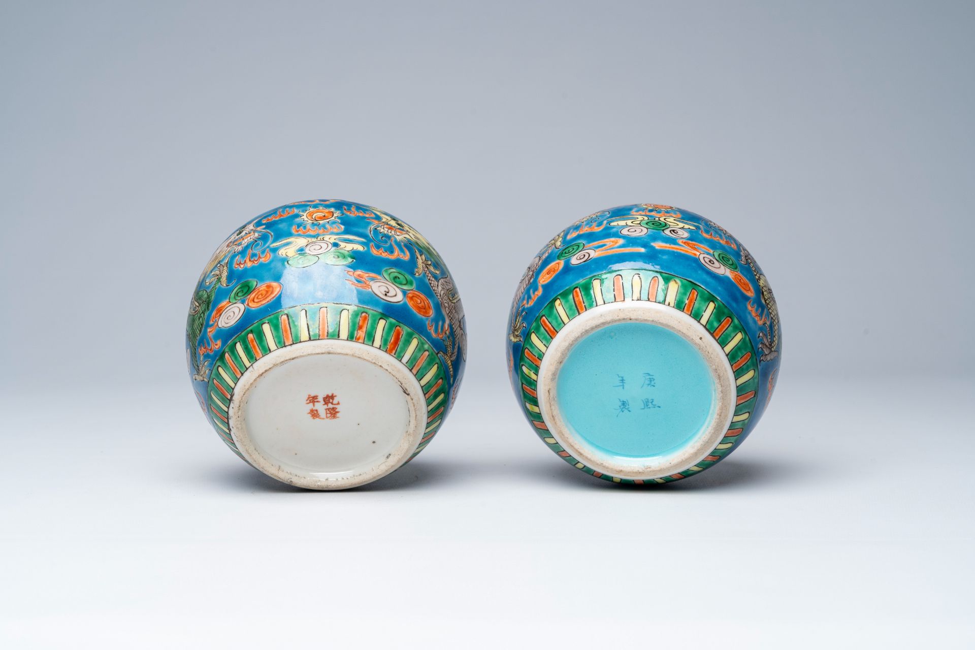 A pair of Chinese blue ground famille verte 'dragons chasing the pearl' ginger jars, 19th C. - Image 7 of 7