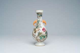 A Chinese qianjiang cai vase with a crane among blossoming branches and elephant head shaped handles
