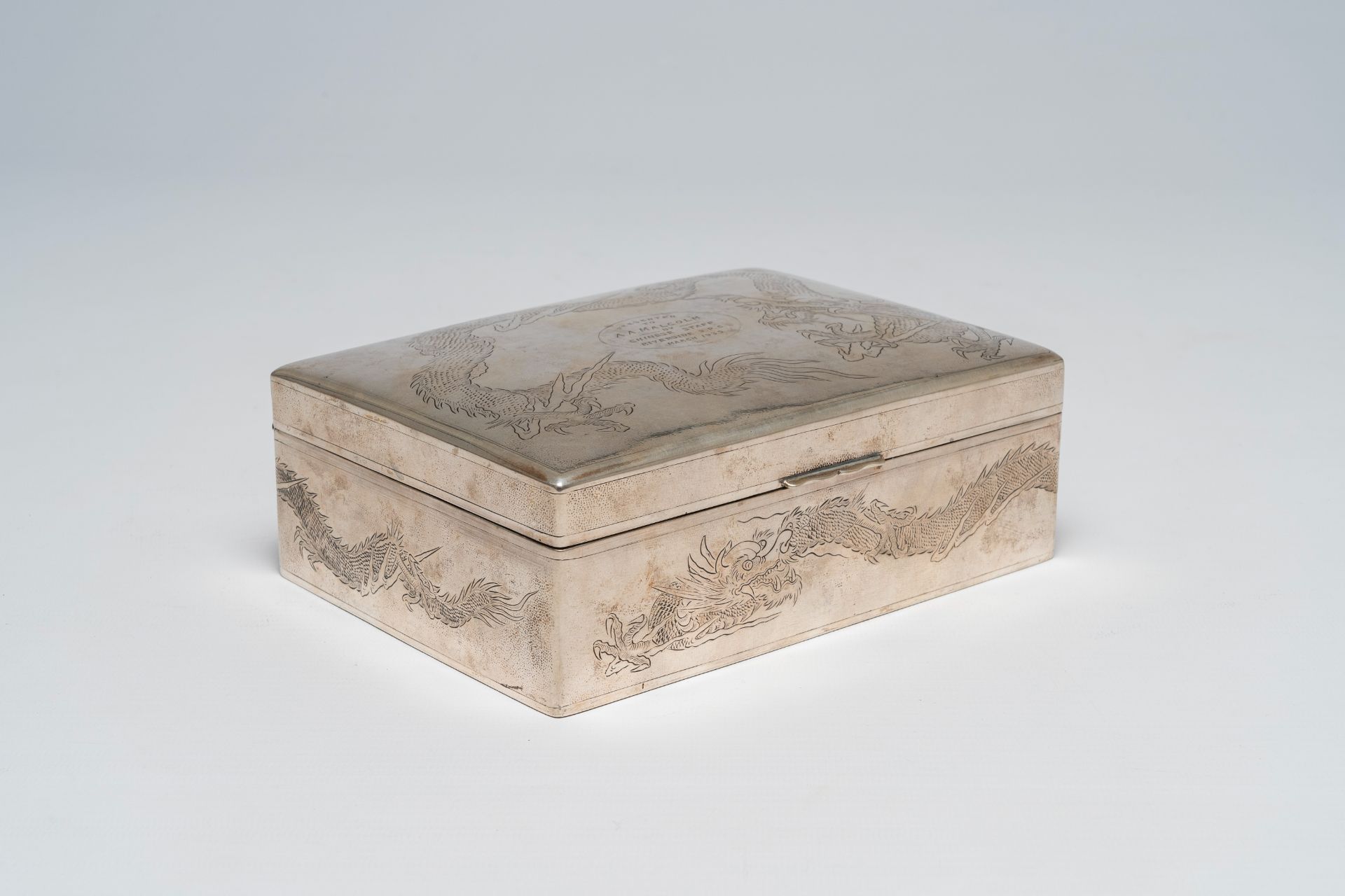 A Chinese silver box and cover with engraved dragon design, maker's mark Wing On & Company, first ha