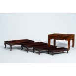 Four Chinese rectangular wood nesting tables and a side table with floral design, 20th C.