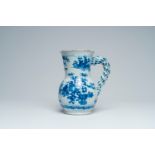 A large French blue and white earthenware 'chinoiserie' jug with floral design, Nevers, 17th C.