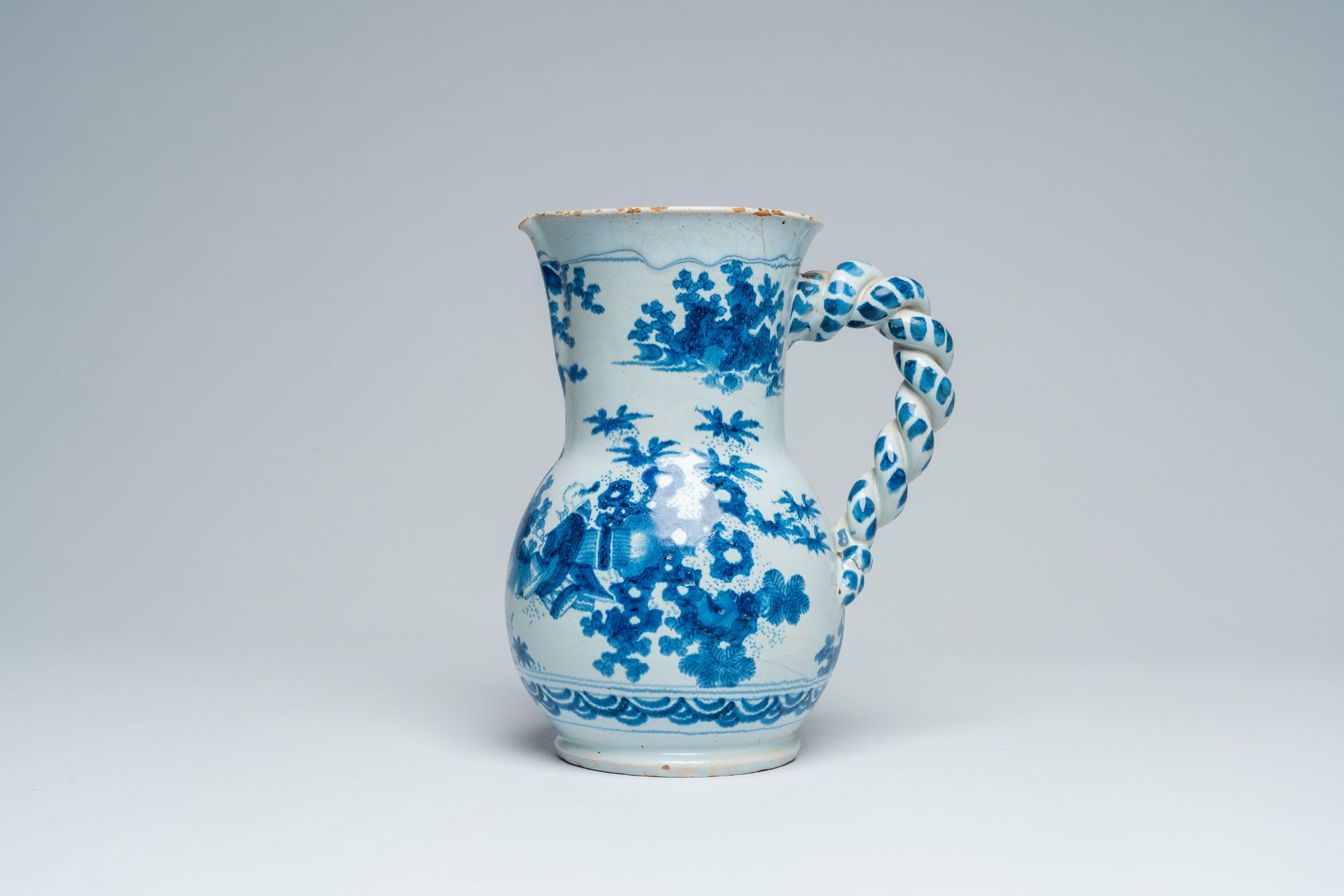 A large French blue and white earthenware 'chinoiserie' jug with floral design, Nevers, 17th C.